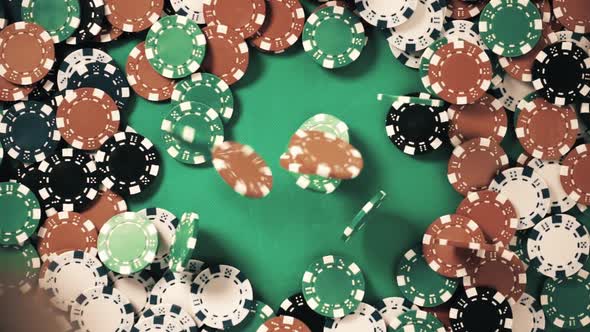 Poker Chips Which Are at Stake Falls From Above on a Green Table in Slow Motion alt
