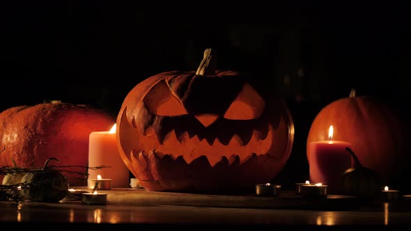 Illuminated Carved Traditional Jack-o-lantern in a Dark Room.