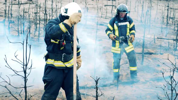 Burntout Ground is Getting Damped Down By the Firemen alt