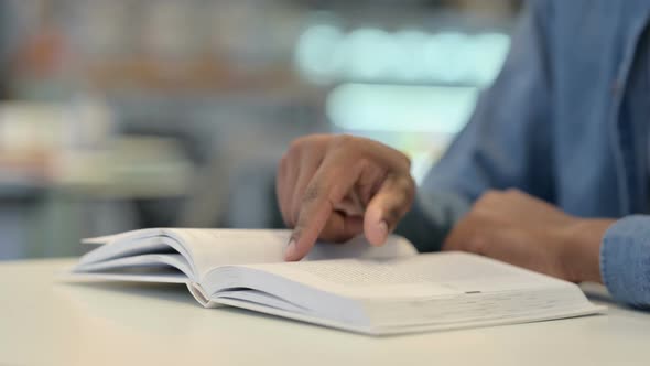Close Up of African Man Reading Book alt