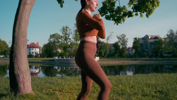 Female practicing reverse lunges outdoors in the morning