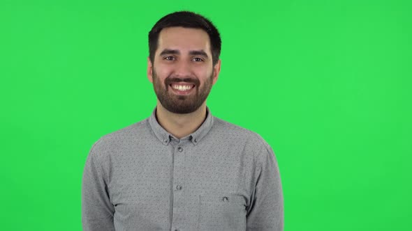 Portrait of Brunette Guy Is Laughing. Green Screen alt