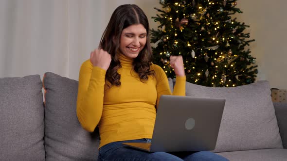 Excited Woman Winner Looks at Laptop Celebrating Good Online New Year Purchase alt