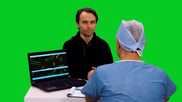 Doctor Talking To Patient Near Computer Display With Results