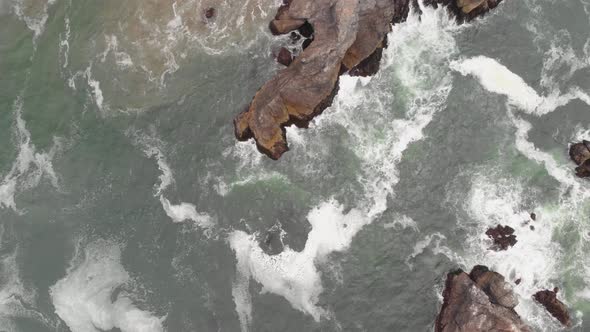 Top down aerial view of the waves crashing on the Sonoma Coast in California. alt