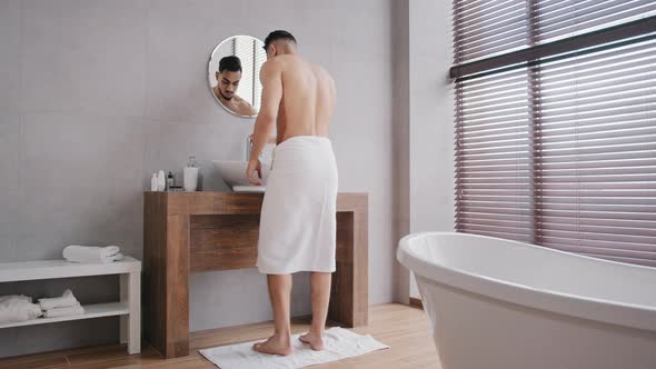 Naked Bare Sexy Muscular Arab Indian Man Enters Going Walking in Bath After Shower with White Towel alt