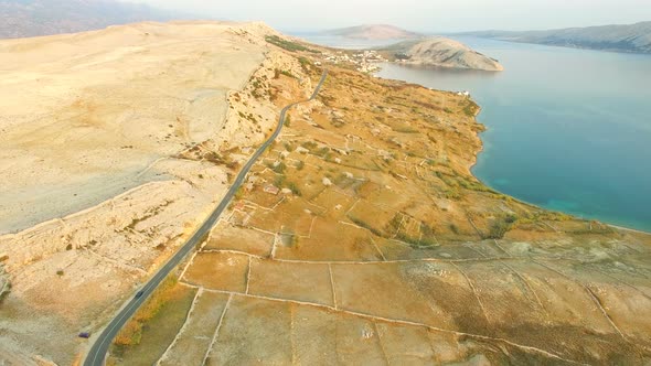 Aerial view of road through desert landscape of Pag island in Croatia alt