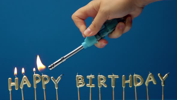 The Hand Makes Lights Candles Happy Birthday with a Lighter 