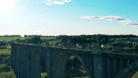 Sports Tourist Is Crossing the Desolated Bridge and Enjoying the View alt