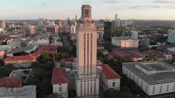 Slow drone approach of the tower at UT. Shot during sunset with Downtown in the background. alt