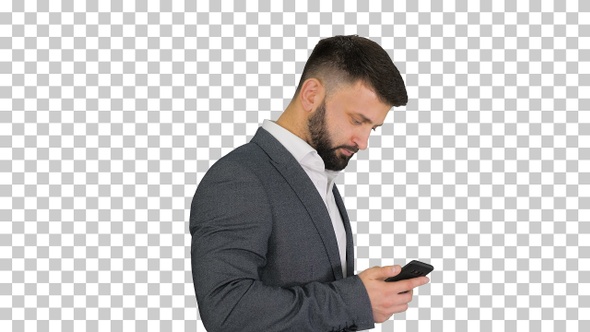 Turk businessman walking and using smartphone, Alpha Channel alt