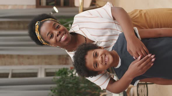 Portrait Of Afro Woman With Cute Son alt