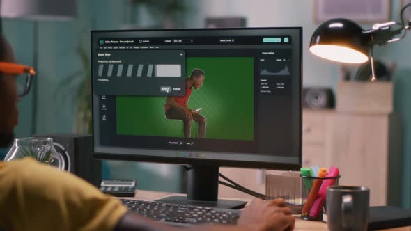 Black Male Editing Chromakey Background on Video alt