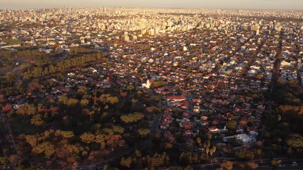 circular drone view of the residential area in the city of Buenos Aires at sunset with the green sub alt