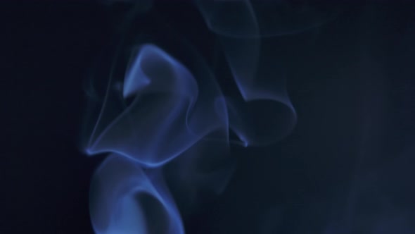 Abstract Smoke Cloud. Blue Smoke Slowly Floating Through Space Against Black Background. Close Up alt