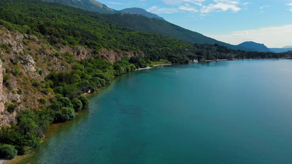 Aerial shot of Macedonia coast. Clif and beautiful water around Ohrid Lake in Southern Europe. alt