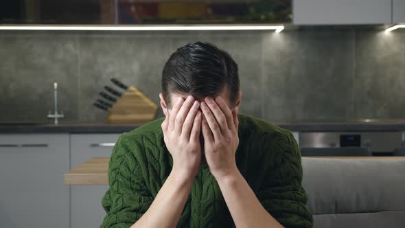 Portrait of Sad Man in Despair Has Mental Problems Sitting on the Couch in the Living Room alt