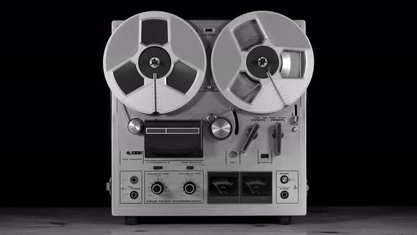 Vintage Reel to Reel tape recorder playing music alt