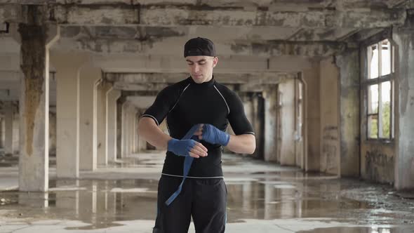 Boxer Wrapping Hands Before Fighting. Young Athlete Getting Ready for Fight alt