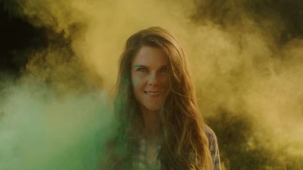 Happy Smiling Woman with Long Hair Having Fun in Colourful Powder of India