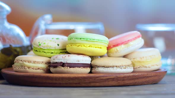 Colorful Macaron on the Table with Hot Tea alt