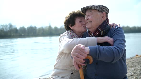 Senior Couple In Love Kissing And Hugging At Riverside Stock Footage