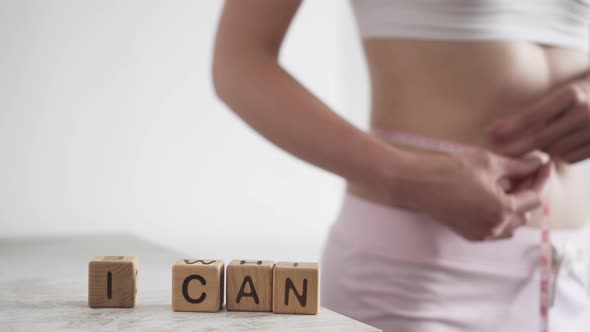 The Girl Measures Her Waist, Next To The Word I Can. I Can Lose Weight. Diet For Weight Loss alt