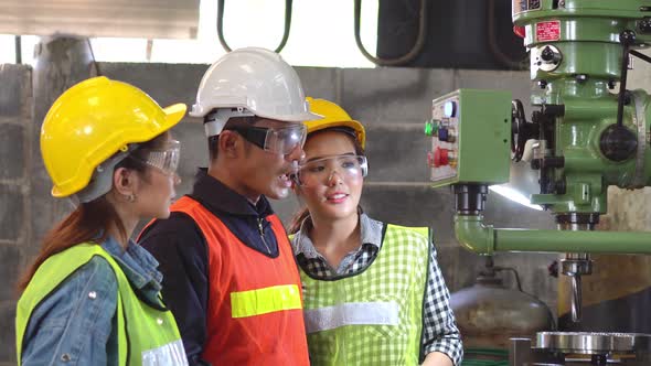 Asian foreman training work to female trainees in the industrial factory alt