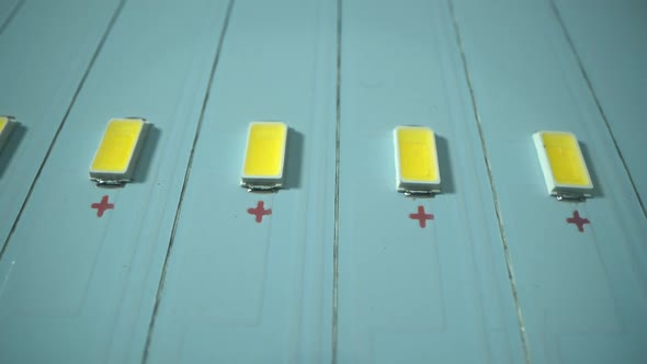 Factory of Create and Manufacture New Mordern Light LED Panels. Dolly Shot Above Panels in Macro alt