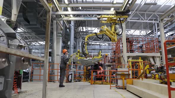 BELARUS BORISOV September 29 2021 Modern Assembly of Cars at the Plant Factory Workers in Uniform