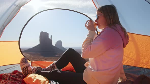 Happy Attractive Young Woman Drinking Warm Tea Camping in Canyon Mountains alt