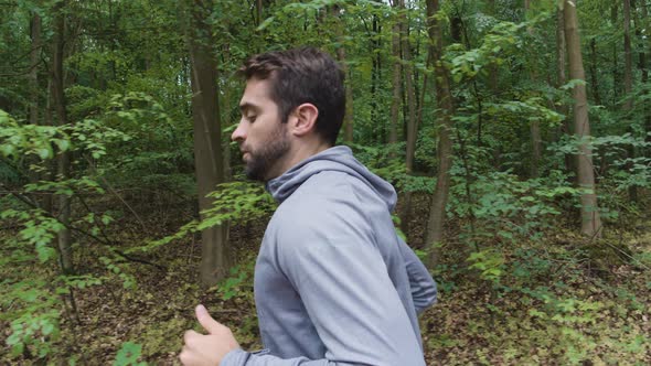 Athlete Jogging Through Forest