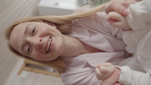 POV of Loving Mother Talking to Baby in Crib alt