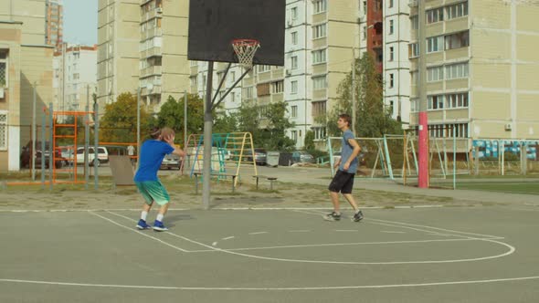 Two Teenage Friends Practicing Basketball Skills alt