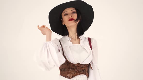 Model in Trendy Clothes Changes Her Poses in the Studio alt