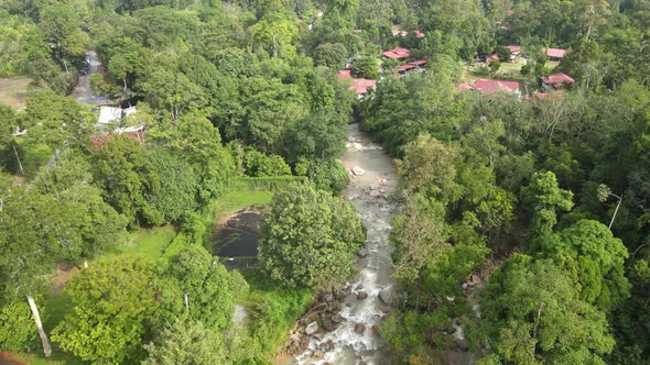 Aerial view of river, chalet and jungle in Pahang