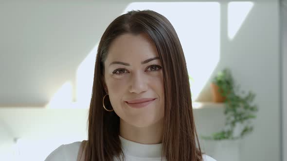 Closeup Portrait Smiling Spanish Woman at Camera in an Office or Apartment alt