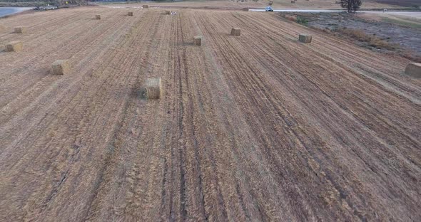 Aerial Footage Above a Hay Field with a Stacks of Hay
