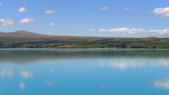 Lake landscape, clouds reflection on water at Lake Pukaki, New Zealand alt