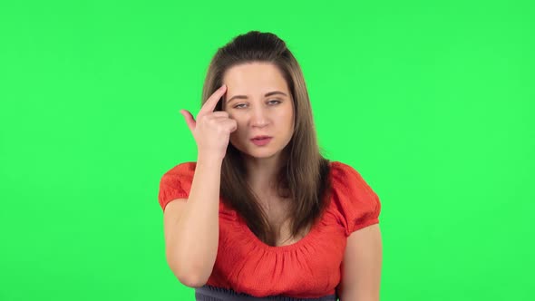Portrait of Angry Girl Is Waving Her Hands in Indignation, Shrugs. Green Screen alt