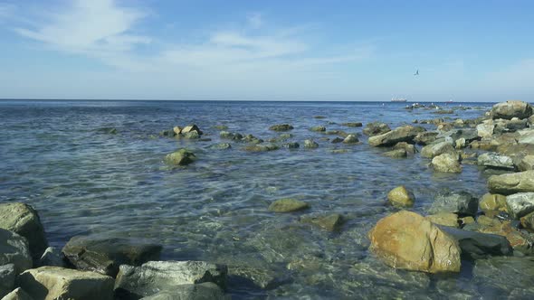 Sea Rocky Shore with Clear Blue Water