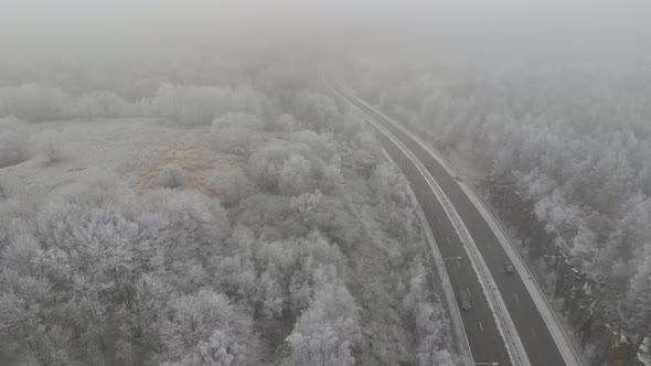Foggy Landscape With Long Country Road Winter Weather Pull Back Aerial
