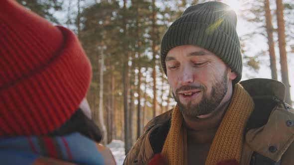 Happy Man and Woman on Date in Forest in Winter alt