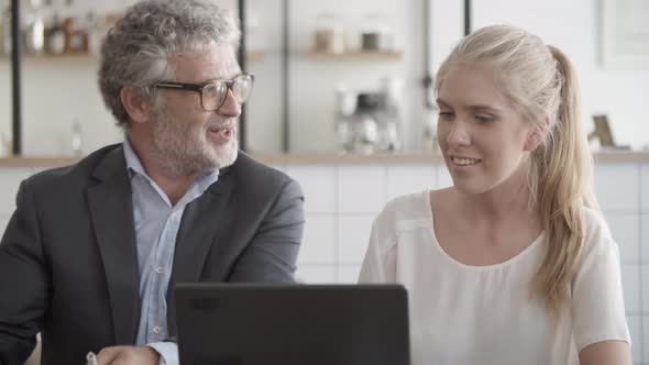 Professional Senior Manager Discussing Project and Signing alt