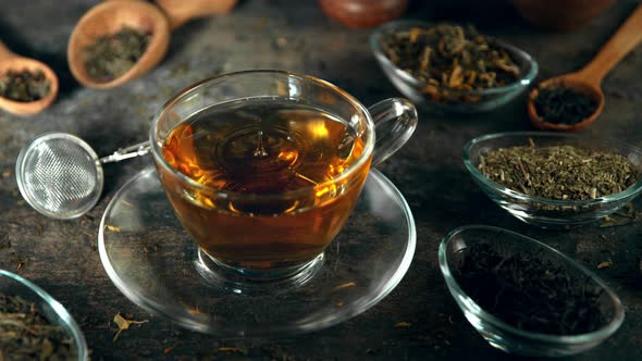 Super Slow Motion Shot of Droplet Falling Into Tea at 1000 Fps with Still Life Background alt