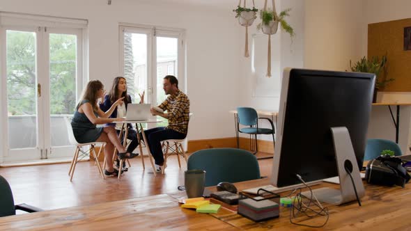 Millennial creative professionals working in a creative office alt