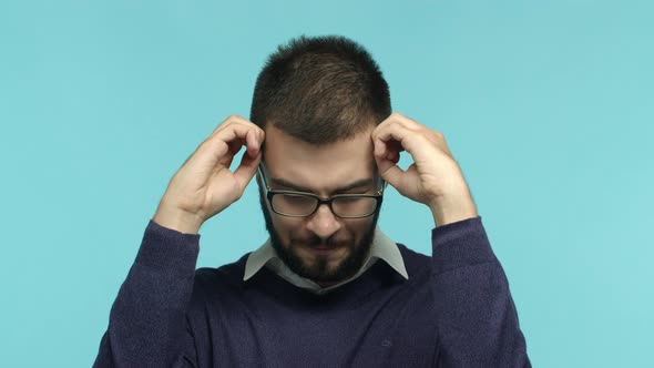 Slow Motion of Tensed and Tired Male Employee in Glasses Showing Explosion Gesture Making Head Blow