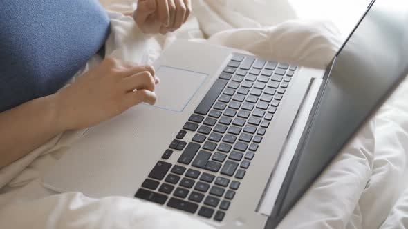 Beautiful Girl in Bed Using Laptop alt