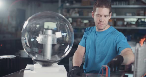 Worker testing LED lamp in an advanced electronics manufacturing facility alt