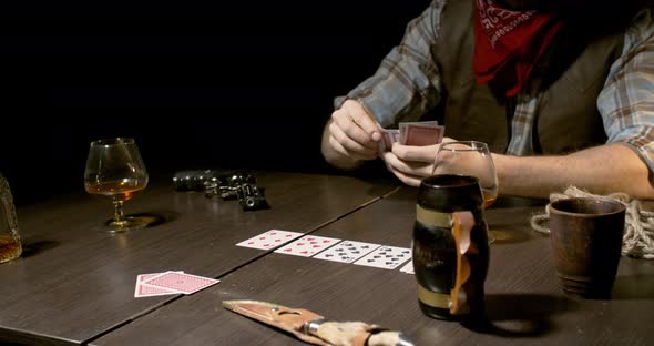 Cowboys are playing poker and drinking whiskey, cards on the table, 4k alt